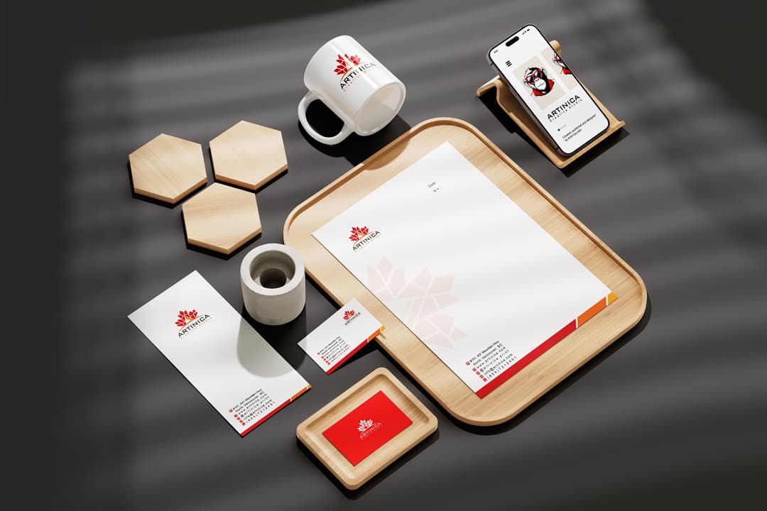 Artinica branded print products — business cards, letterhead, mugs and stationery